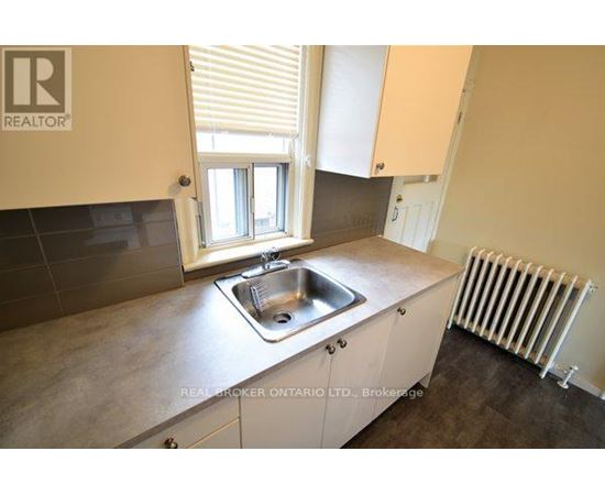 A kitchen with a sink and a window.