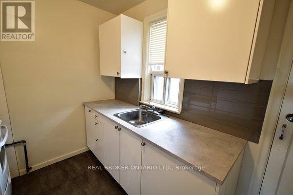 A small kitchen with a sink and cabinets.