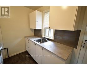 A small kitchen with a sink and cabinets.