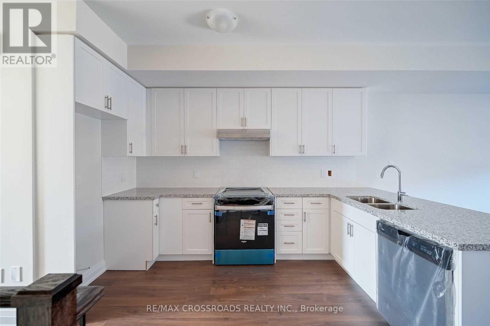 A kitchen with white cabinets and a blue dishwasher.