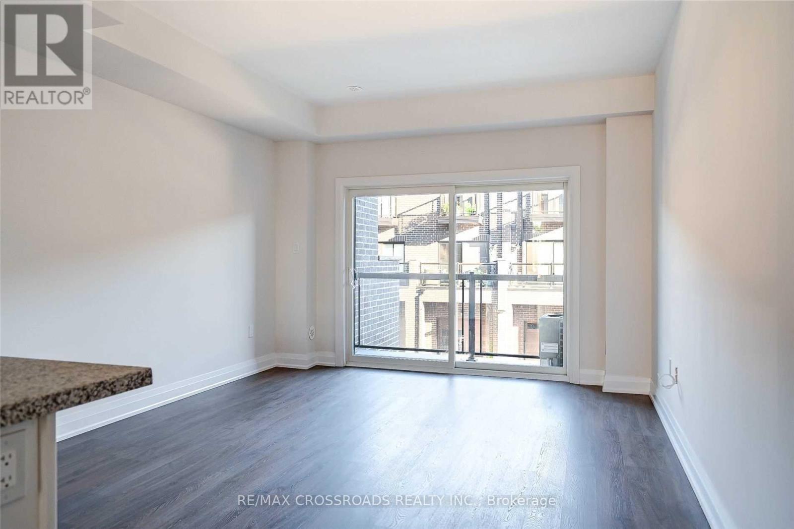A room with a view of a street through a window.