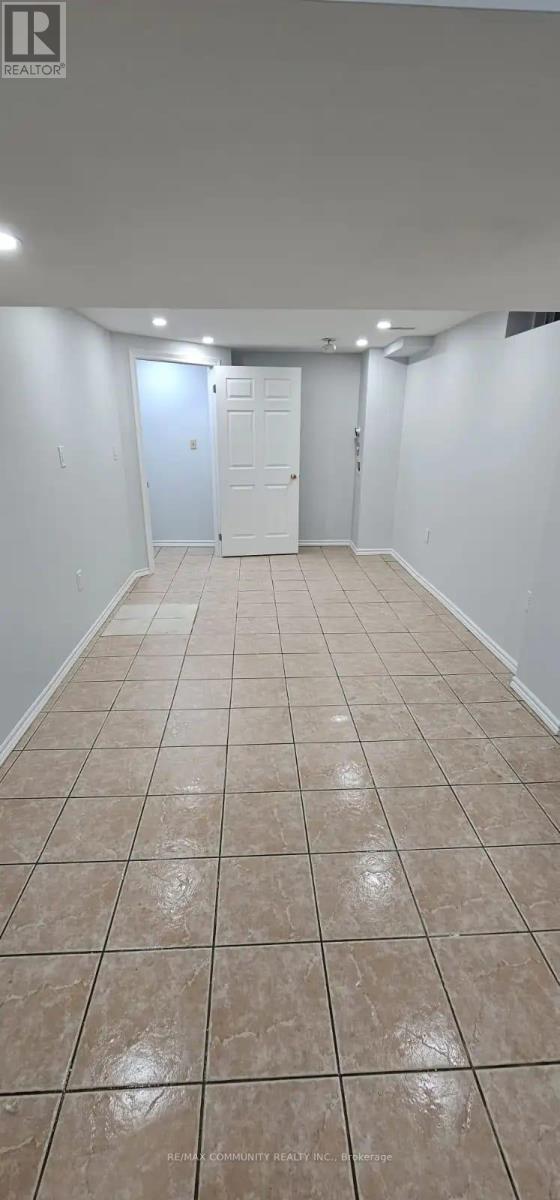 A room with white walls and tile flooring.