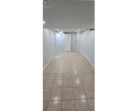 A room with white walls and tile flooring.
