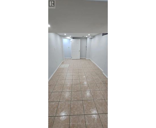 A room with white walls and tile flooring.