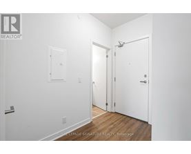 A white room with a door on the right and a window on the left.
