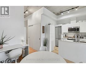 A white kitchen with a dining table and chairs.