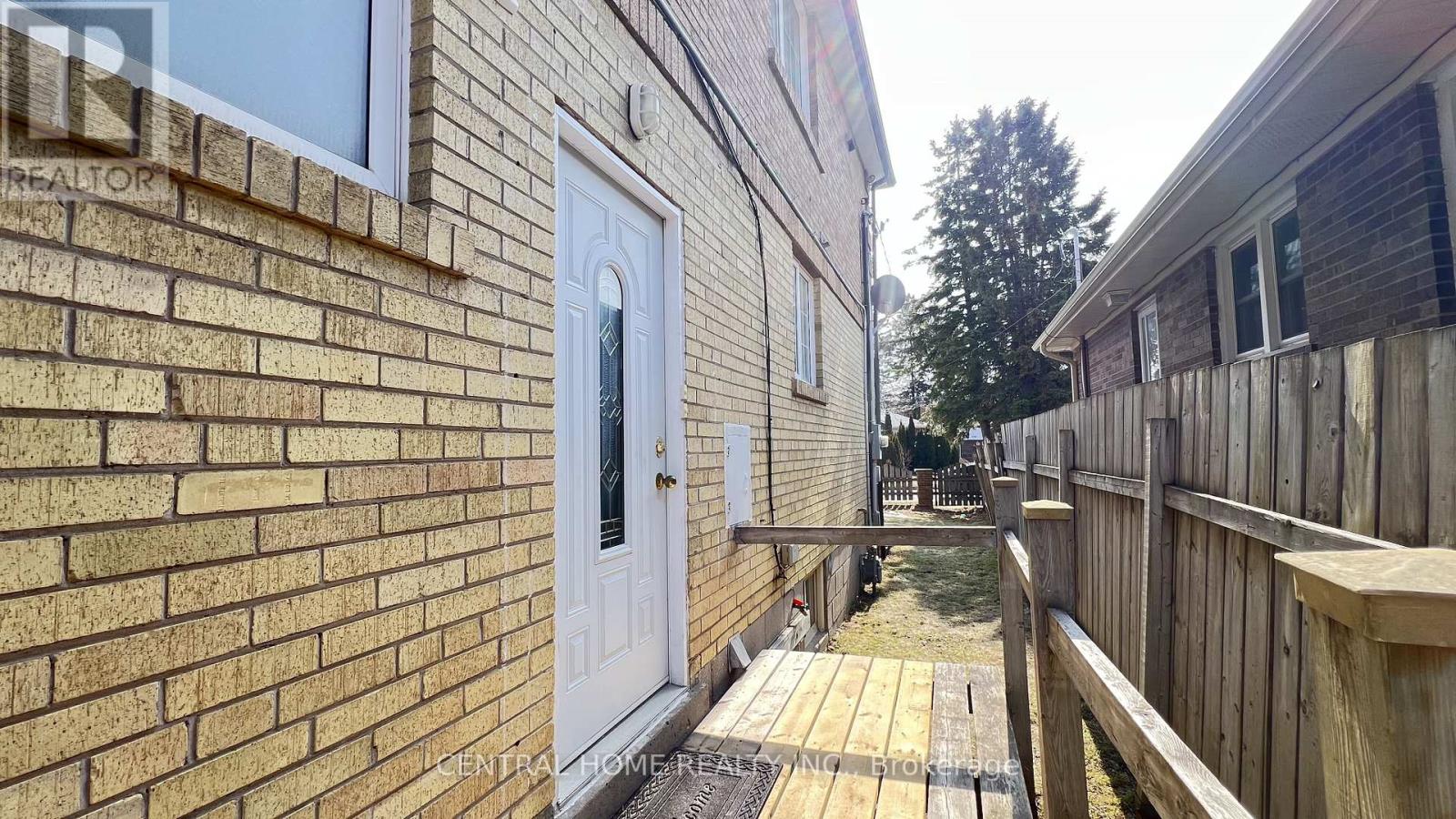 A white door is on a brick building.