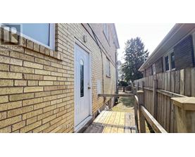 A white door is on a brick building.