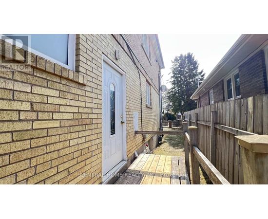 A white door is on a brick building.
