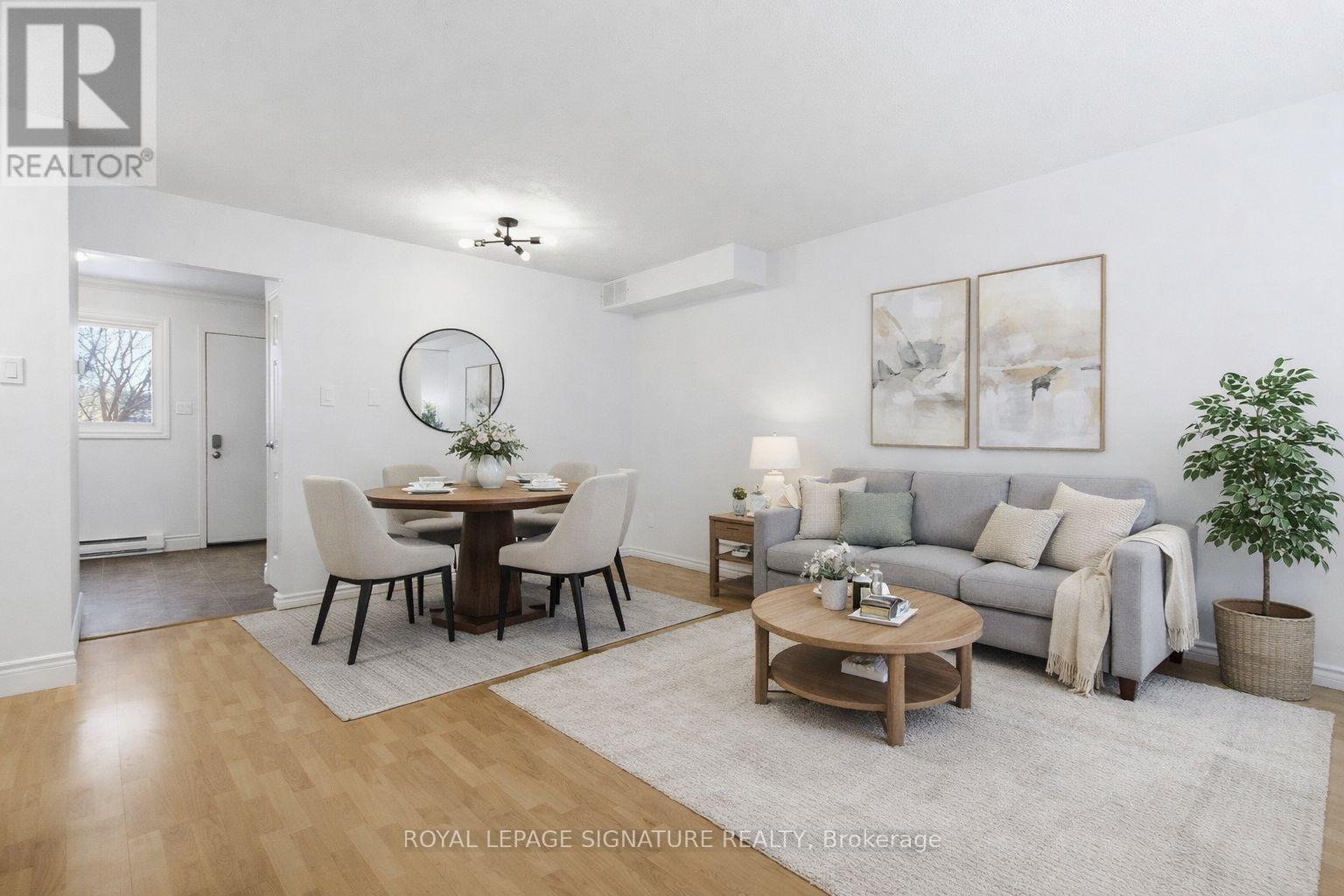 A well-lit, spacious living room with a dining table and a couch.