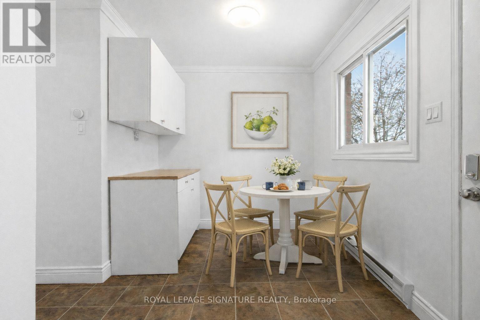 A dining room with a table set for four.