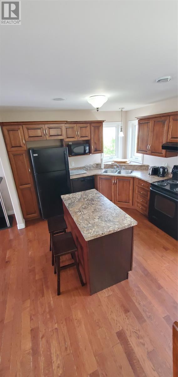 A kitchen with wooden cabinets and a granite countertop.