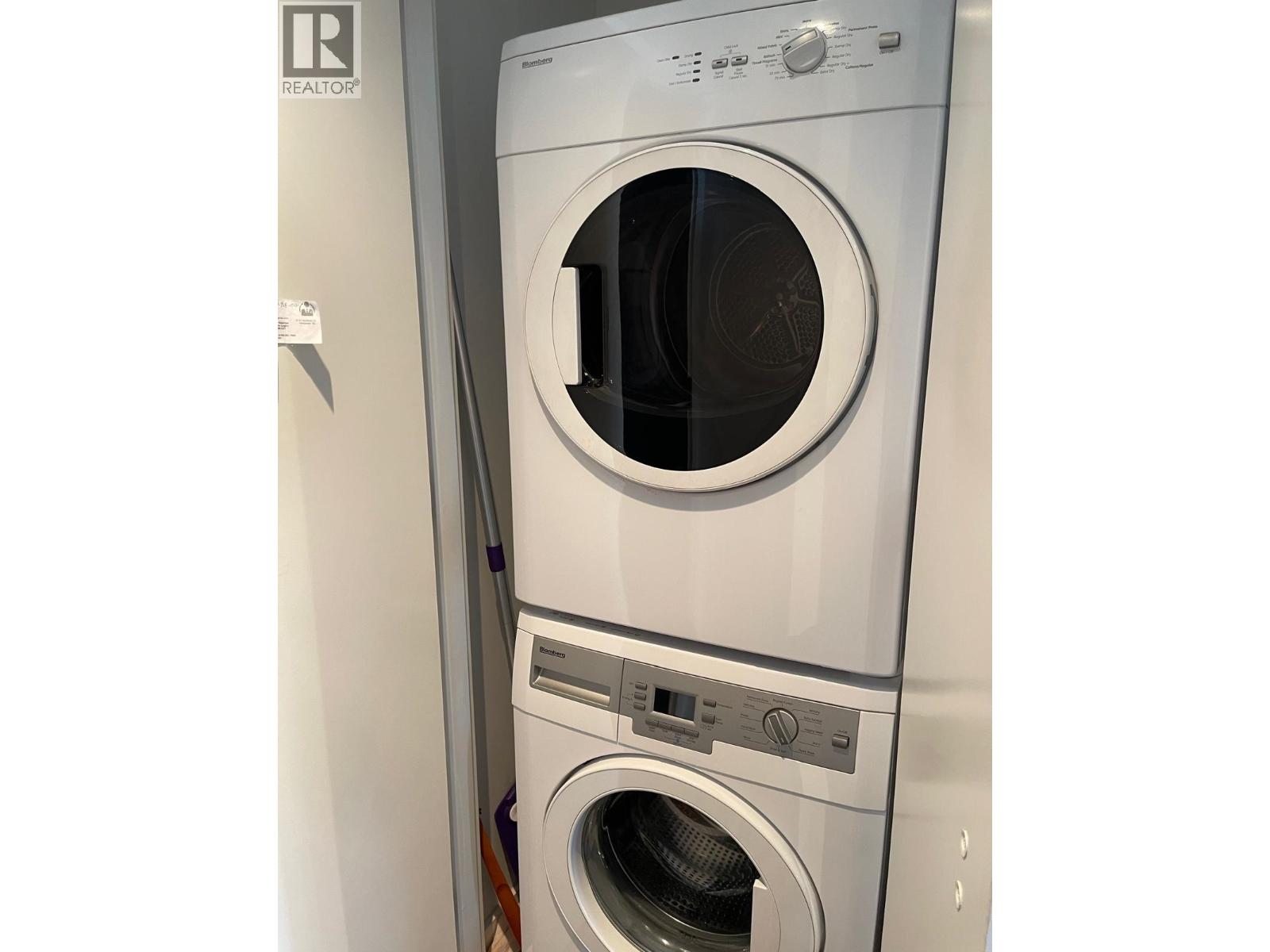 A washing machine and dryer are stacked on top of each other.