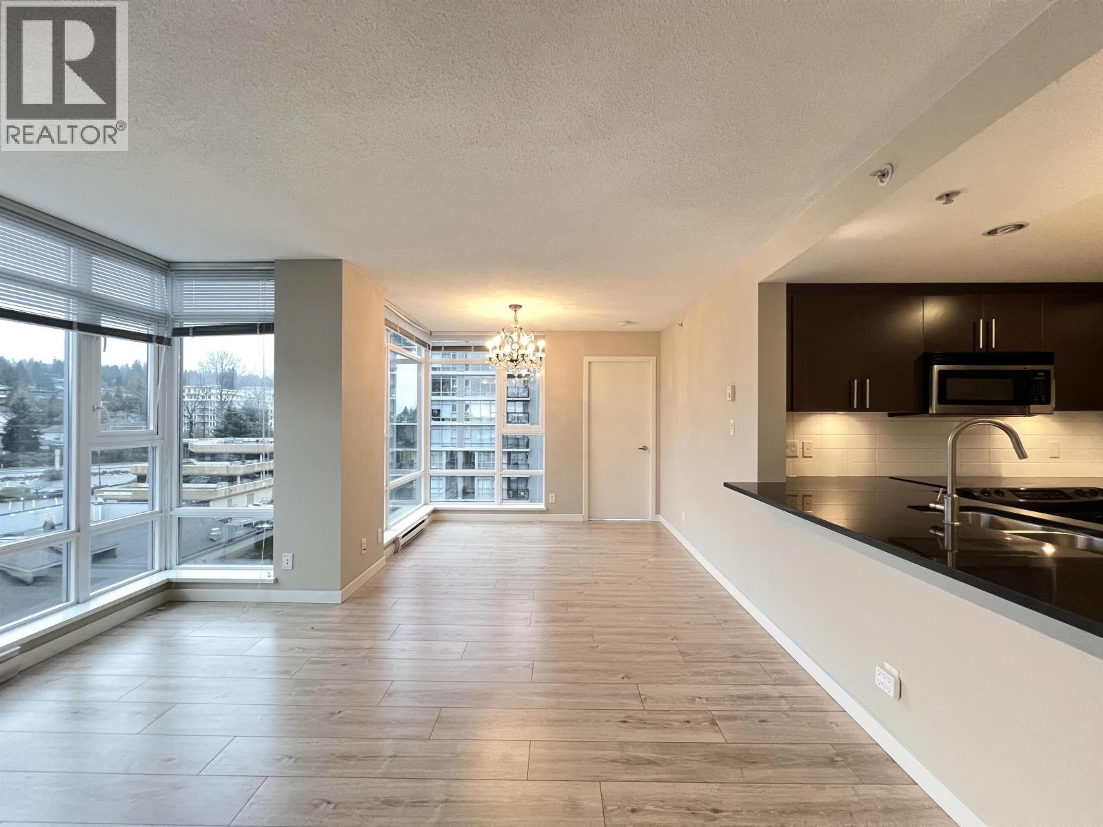 A spacious kitchen with a microwave and a sink.