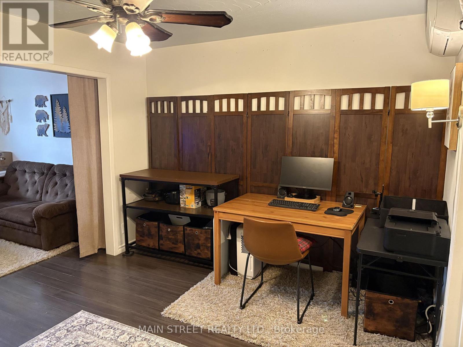 A room with a brown desk and a brown chair.