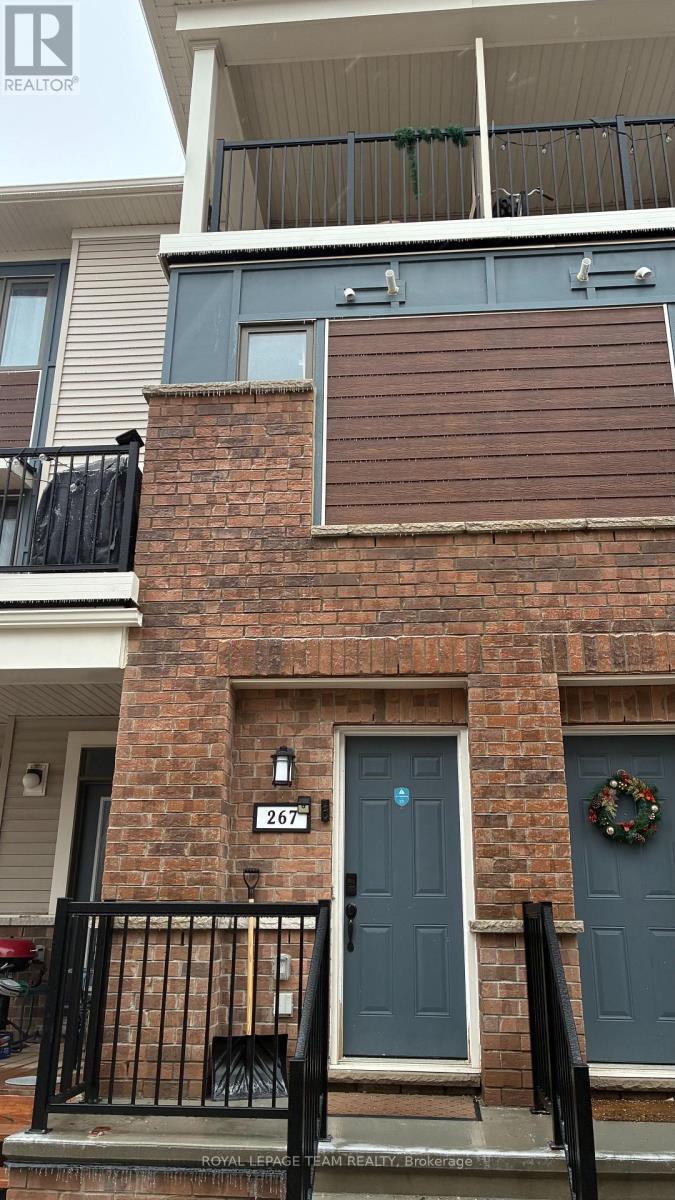 A brick building with a blue door and a wreath on the door.