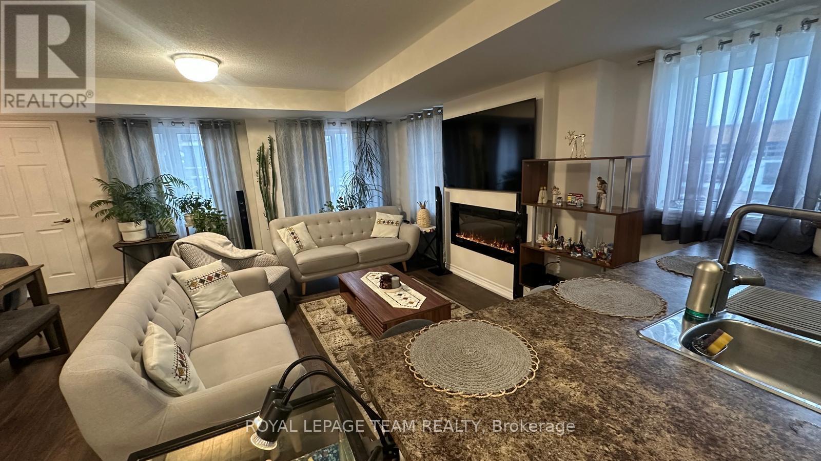 A living room with a white couch and a rug.