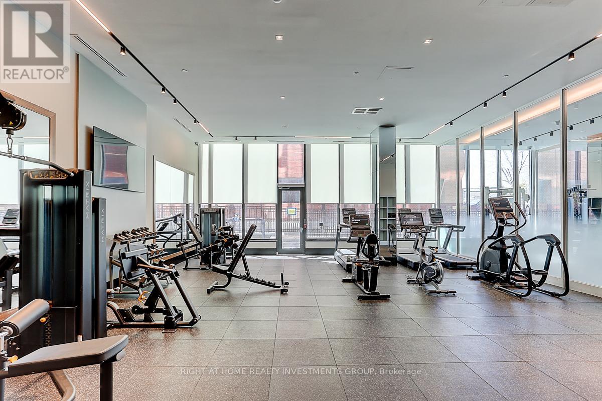 A gym with a variety of equipment including treadmills, stationary bikes, and weight machines.