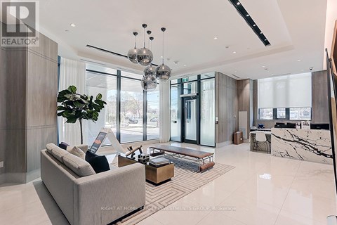 A modern living room with a large grey sofa and a coffee table.