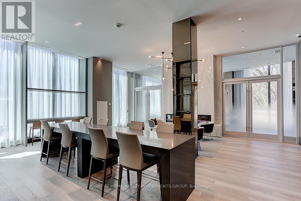 A modern dining room with a long table and chairs.