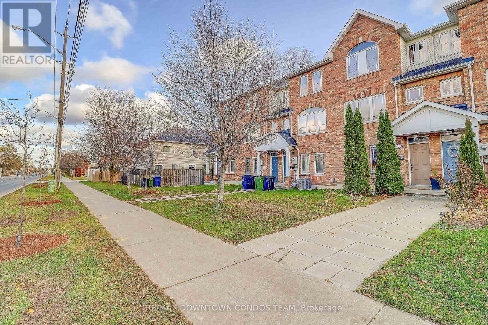 A residential area with houses and a sidewalk.