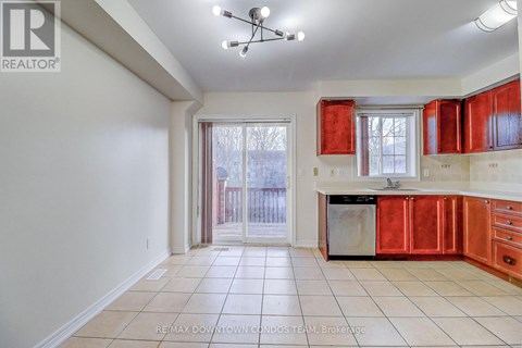 A kitchen with red cabinets and a white ceiling.