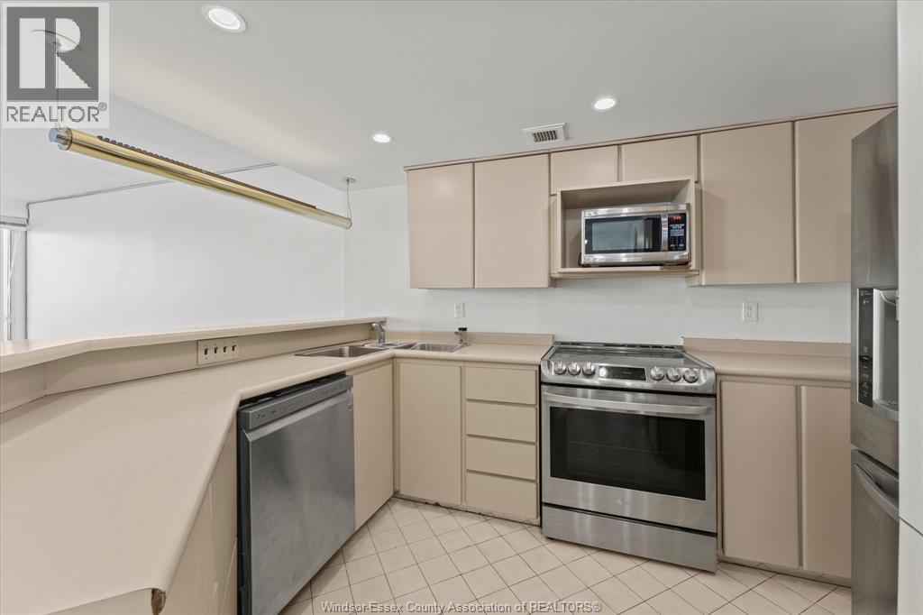 A kitchen with a stove top oven and a microwave above it.