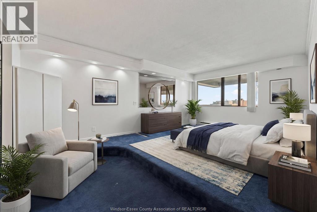 A bedroom with a large bed and a couch.
