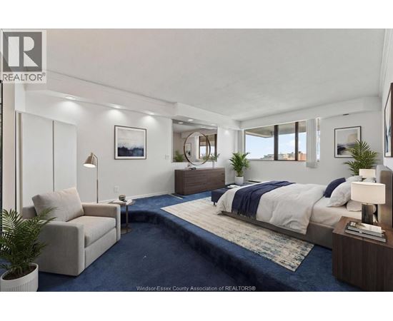 A bedroom with a large bed and a couch.
