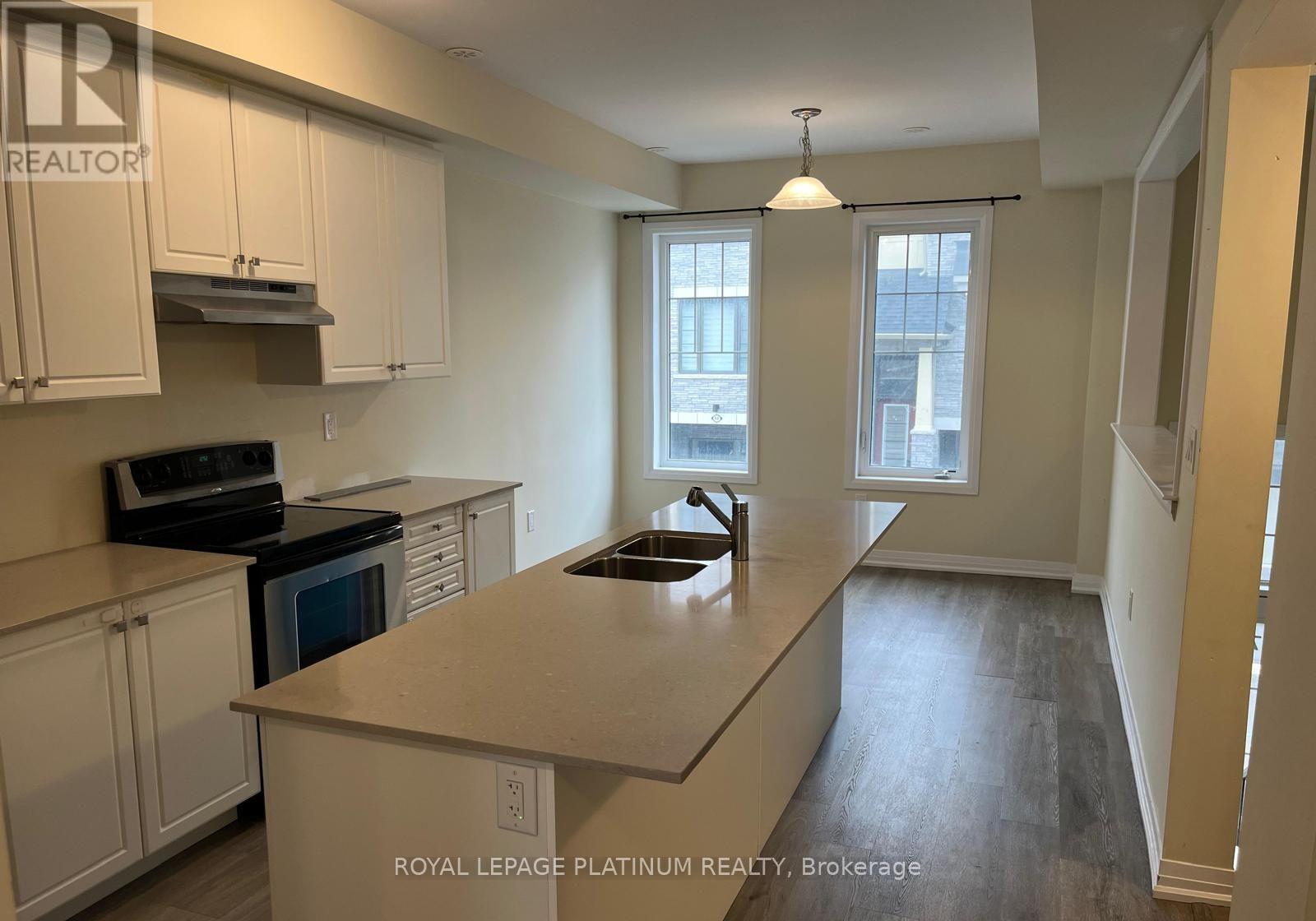 A kitchen with white cabinets and a black stove top oven.