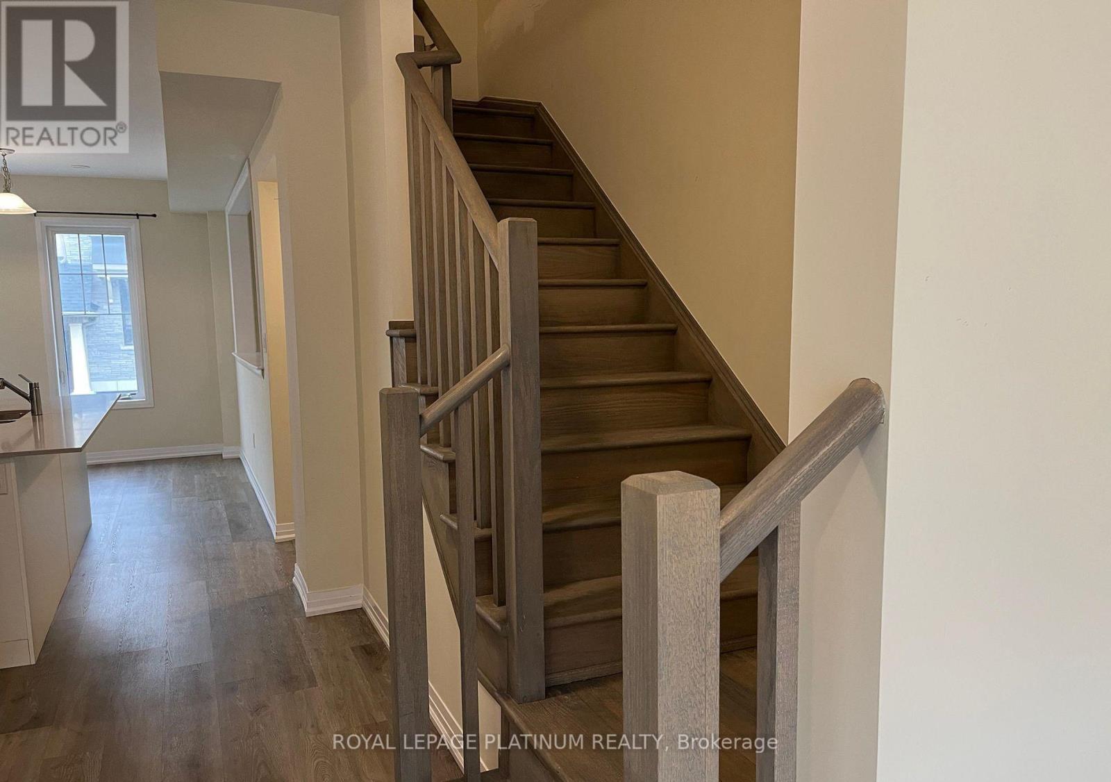 A staircase with a wooden handrail and steps.