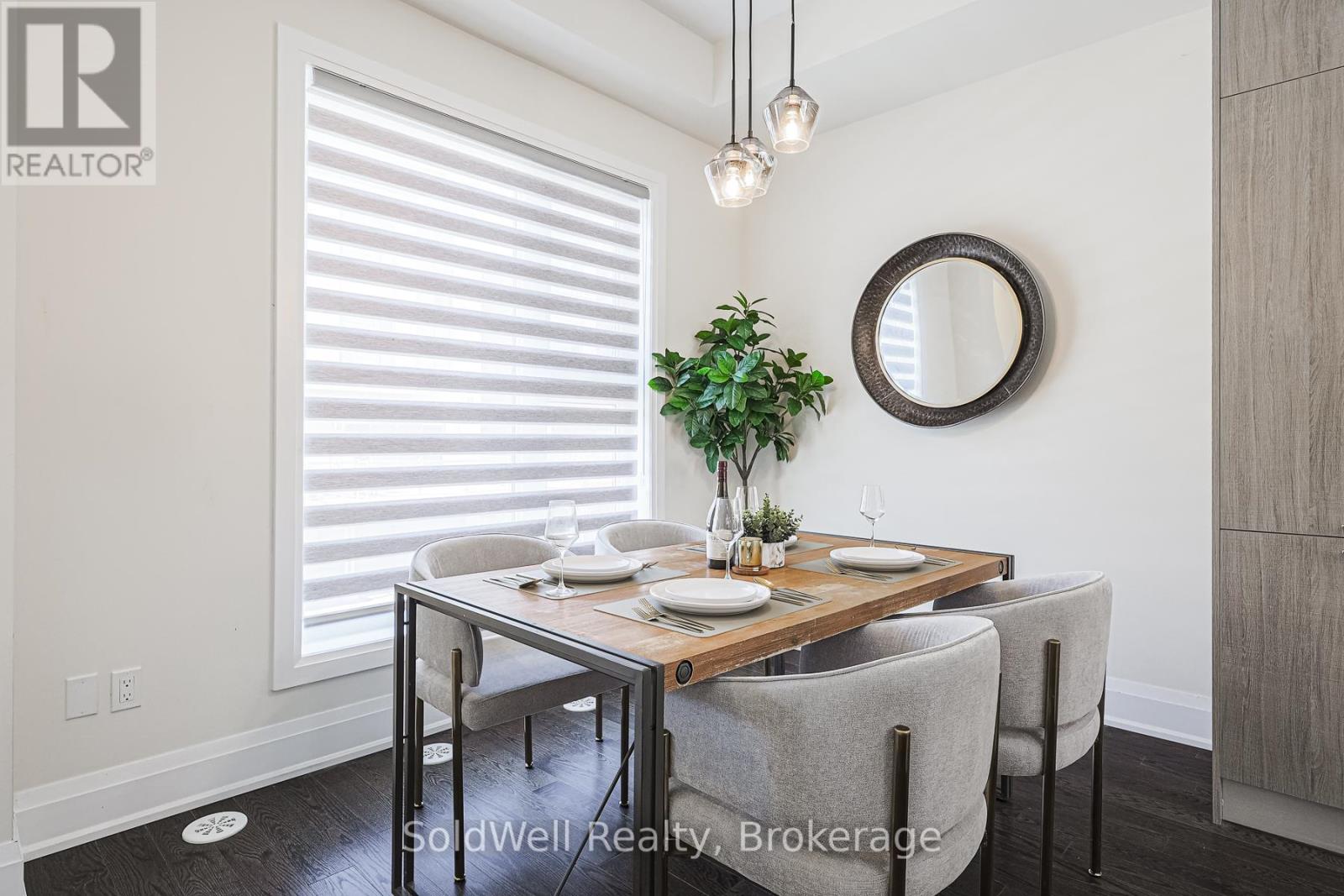 A dining room with a table set for two and a plant on the table.