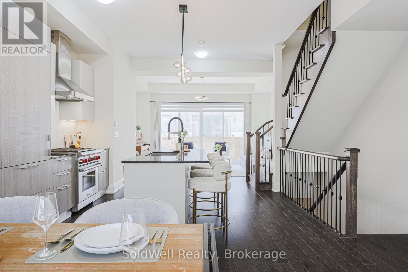 A modern kitchen with a dining table set for two.