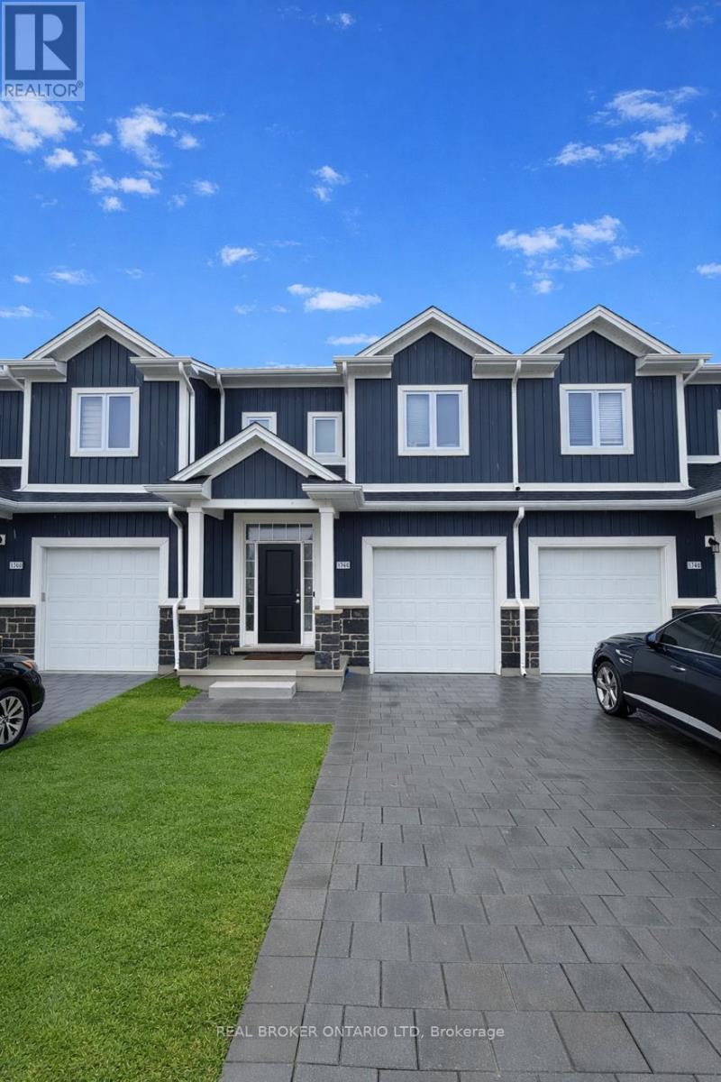 A large house with a grey roof and white garage doors.