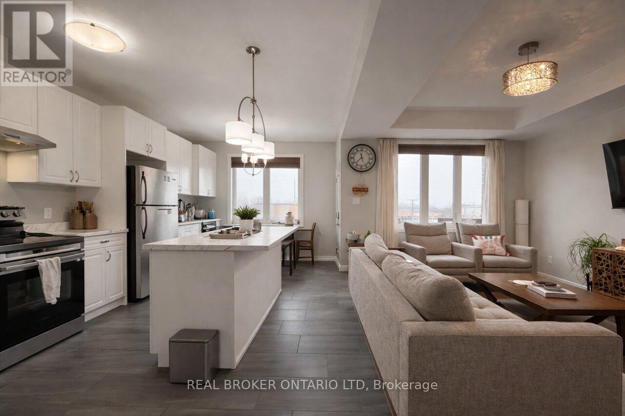 A modern kitchen with white cabinets and a large island.