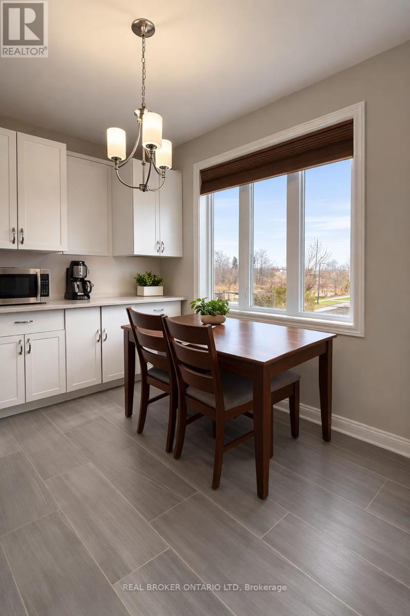 A dining room with a table and chairs.