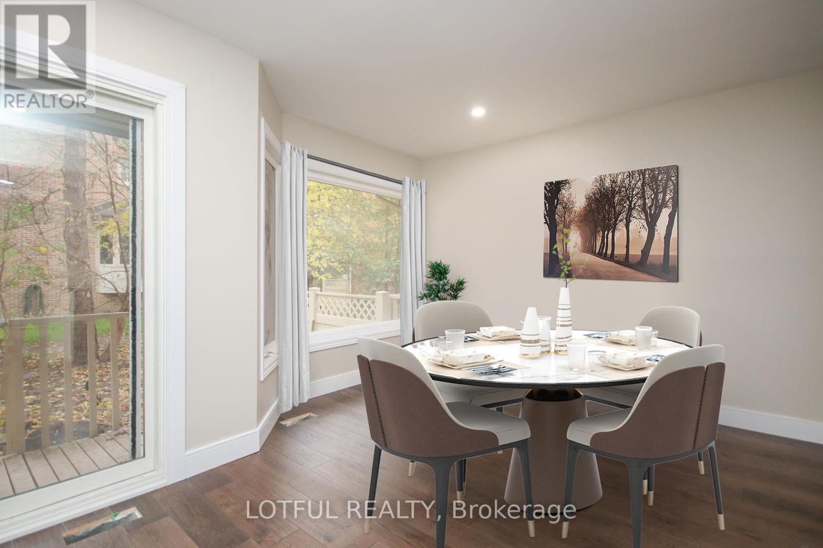 A dining room with a table set for four and a painting on the wall.