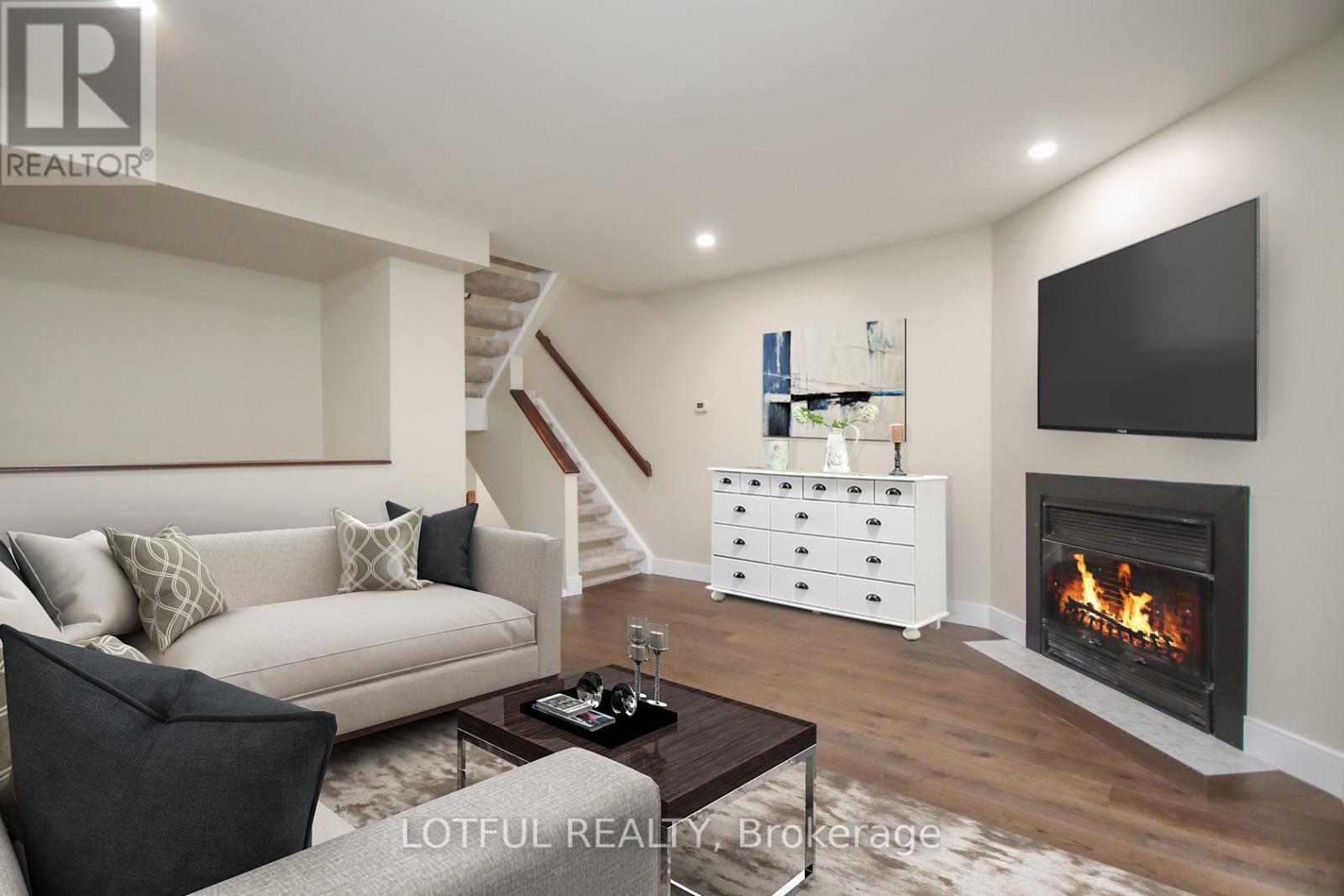 A modern living room with a fireplace and a flat screen TV.