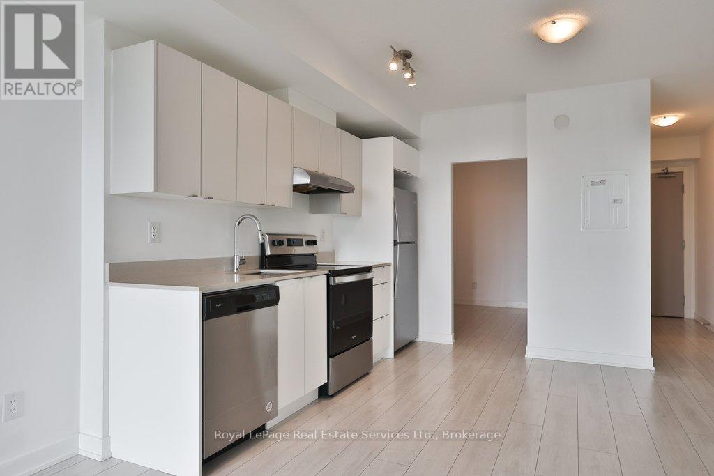A kitchen with white cabinets and stainless steel appliances.