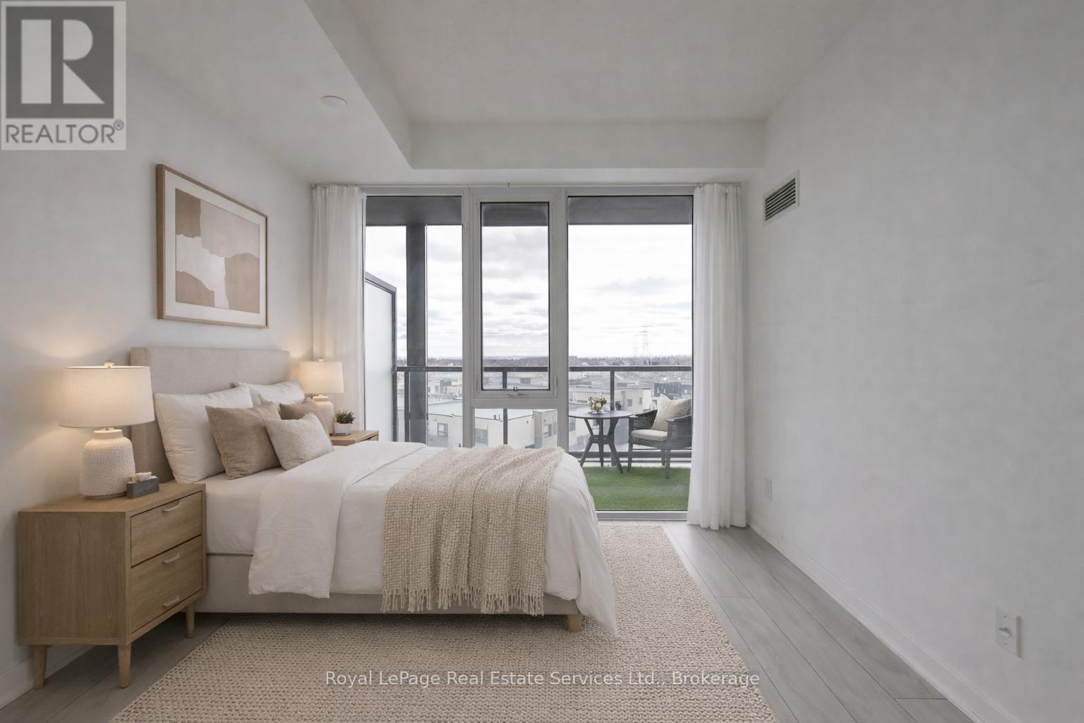 A bedroom with a large bed and a view of the outside.