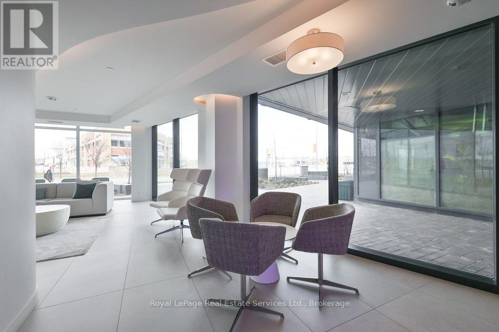 A dining room with a white table and purple chairs.