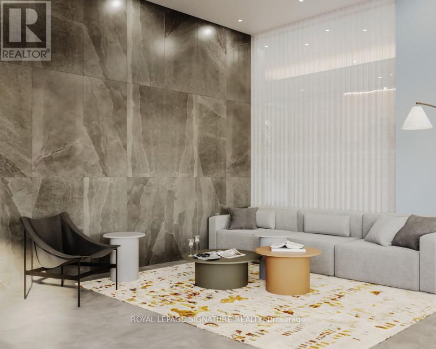 A living room with a grey sofa, a black chair, and a white side table.