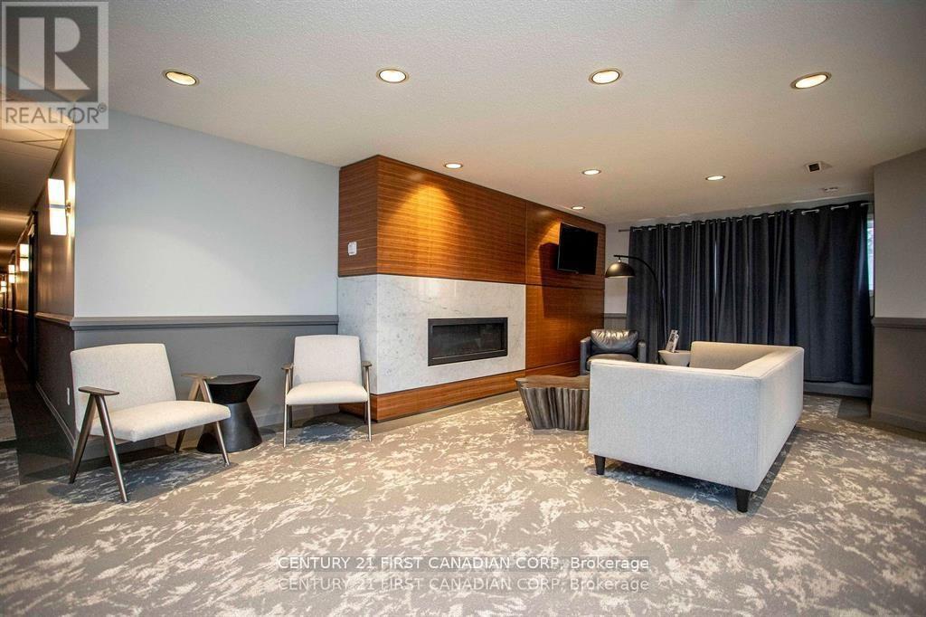 A living room with a fireplace and a grey sofa.