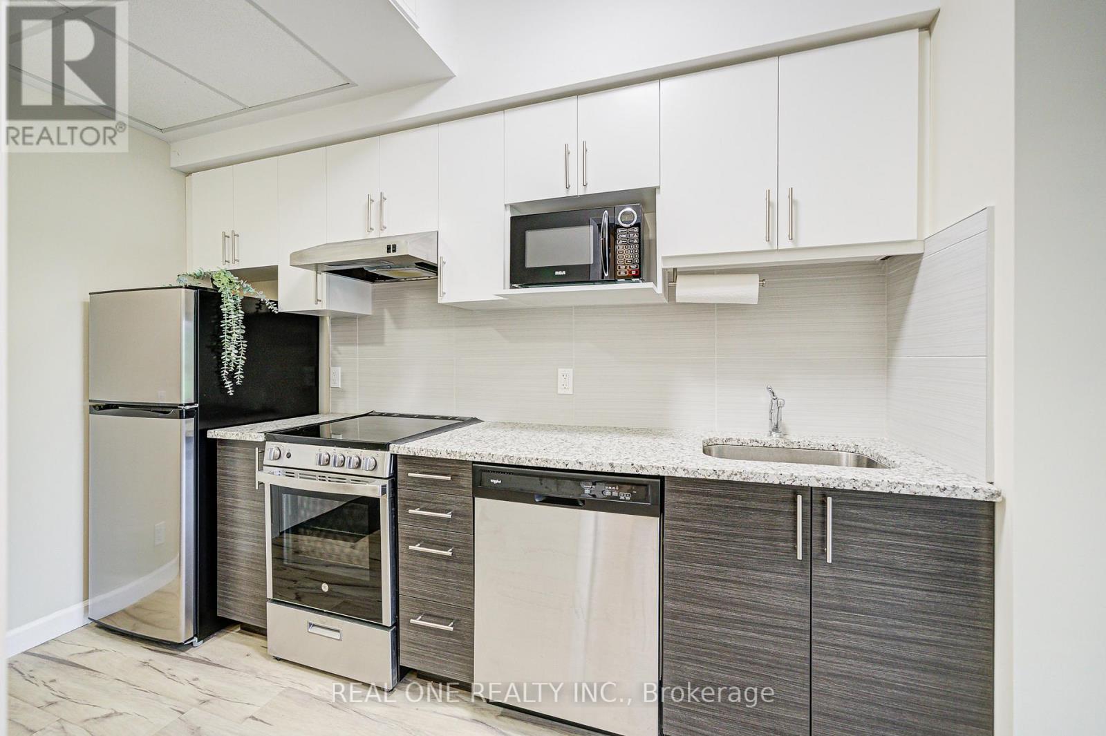 A kitchen with white cabinets and a granite counter top.