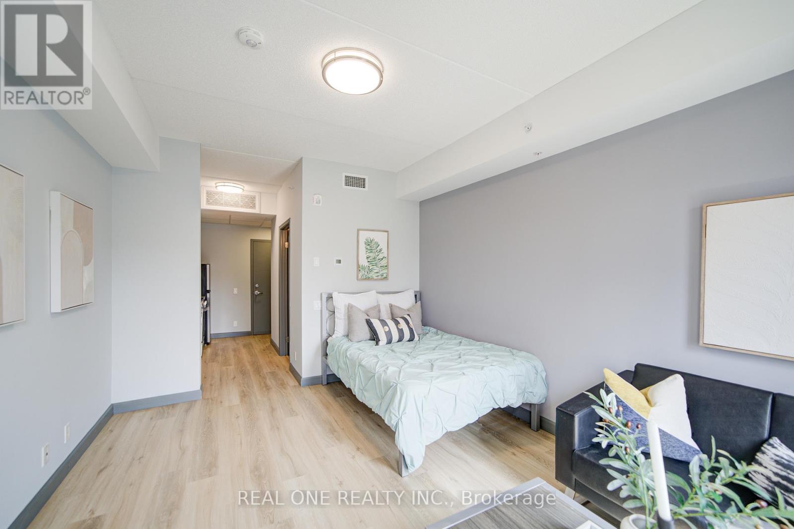 A bedroom with a bed and a couch.