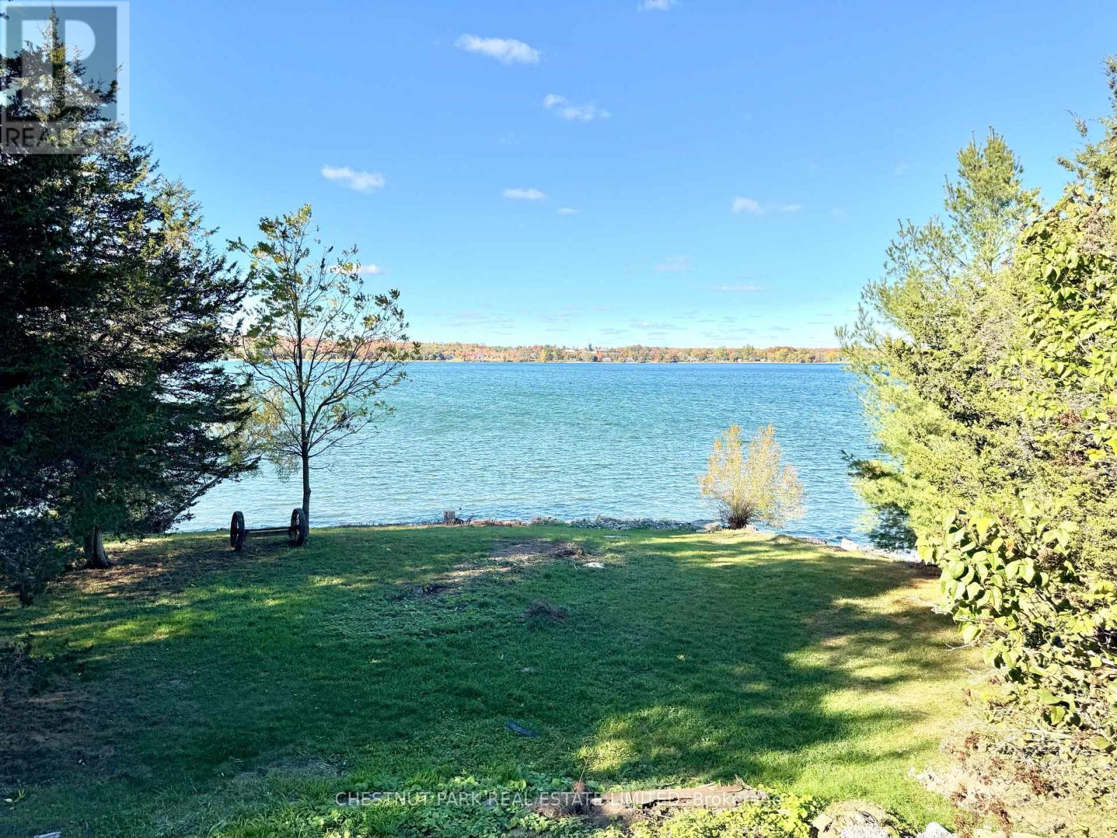 A beautiful park with a lake and trees.