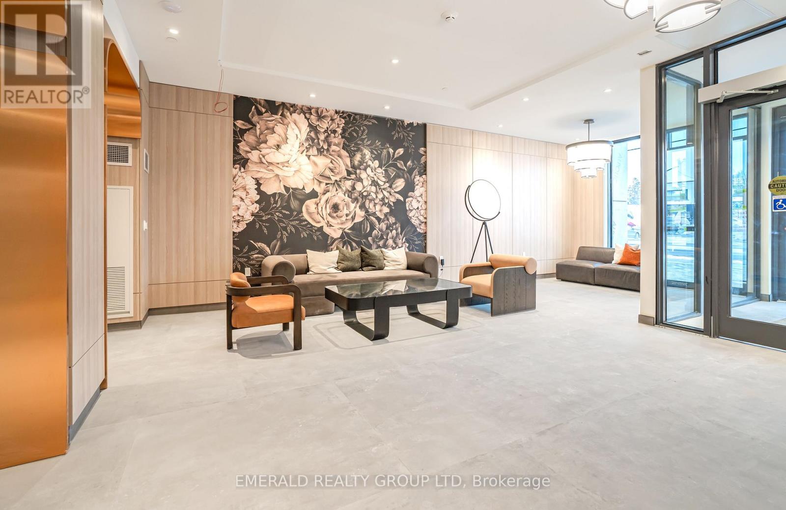 A modern living room with a large floral wallpaper and a variety of seating options.
