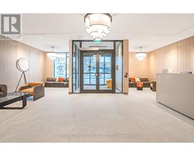 A modern office lobby with a glass door entrance and a reception desk.