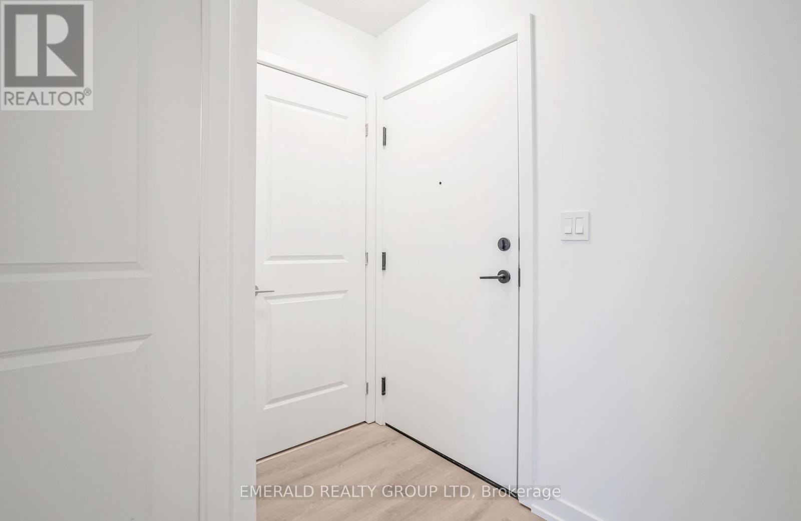 A white door is open to a hallway.