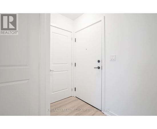 A white door is open to a hallway.